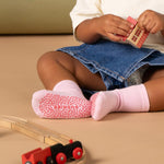 Child wearing pink socks