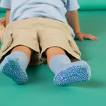 Child wearing blue socks