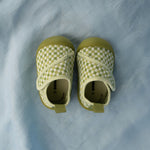 Pair of green checkered baby shoes