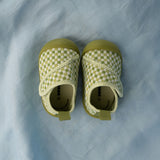 Pair of green checkered baby shoes