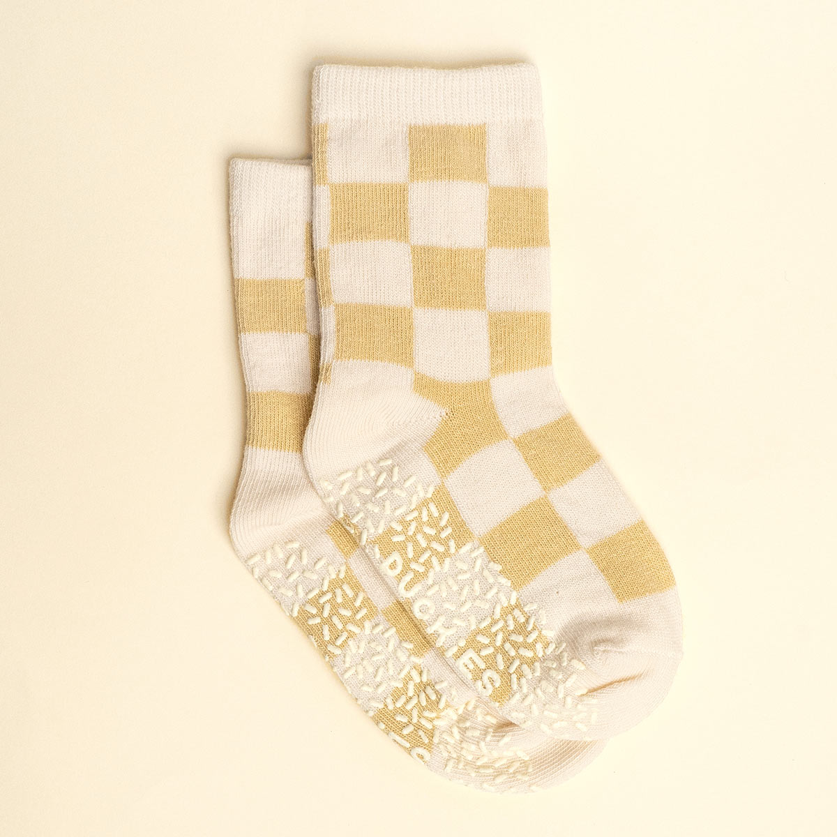 Pair of checkered socks with a beige and white pattern
