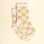 Pair of checkered socks with a beige and white pattern