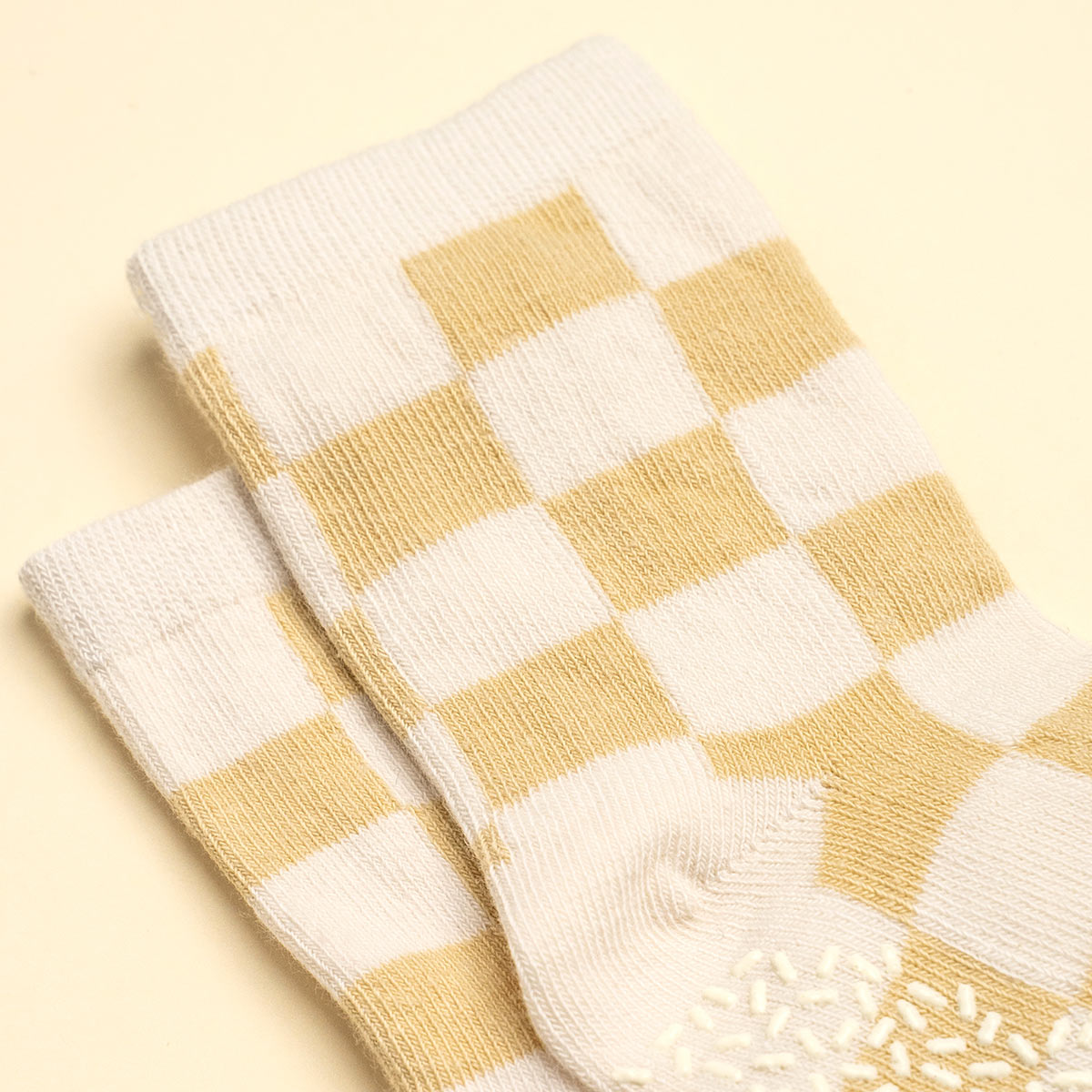 Pair of yellow and white checkered socks