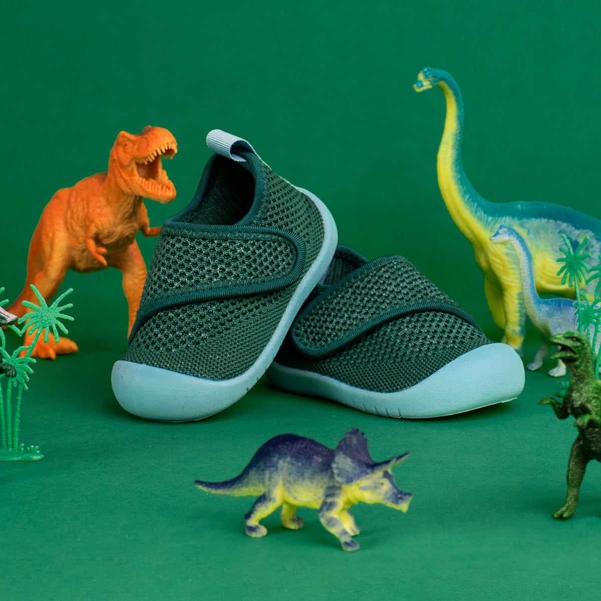 Green sneakers with white soles